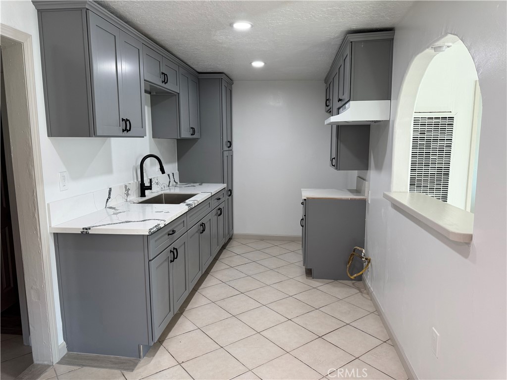 5263 35th Street Jurupa Valley, CA 92509 - Photo 9 of 19 a kitchen with a sink cabinets and window