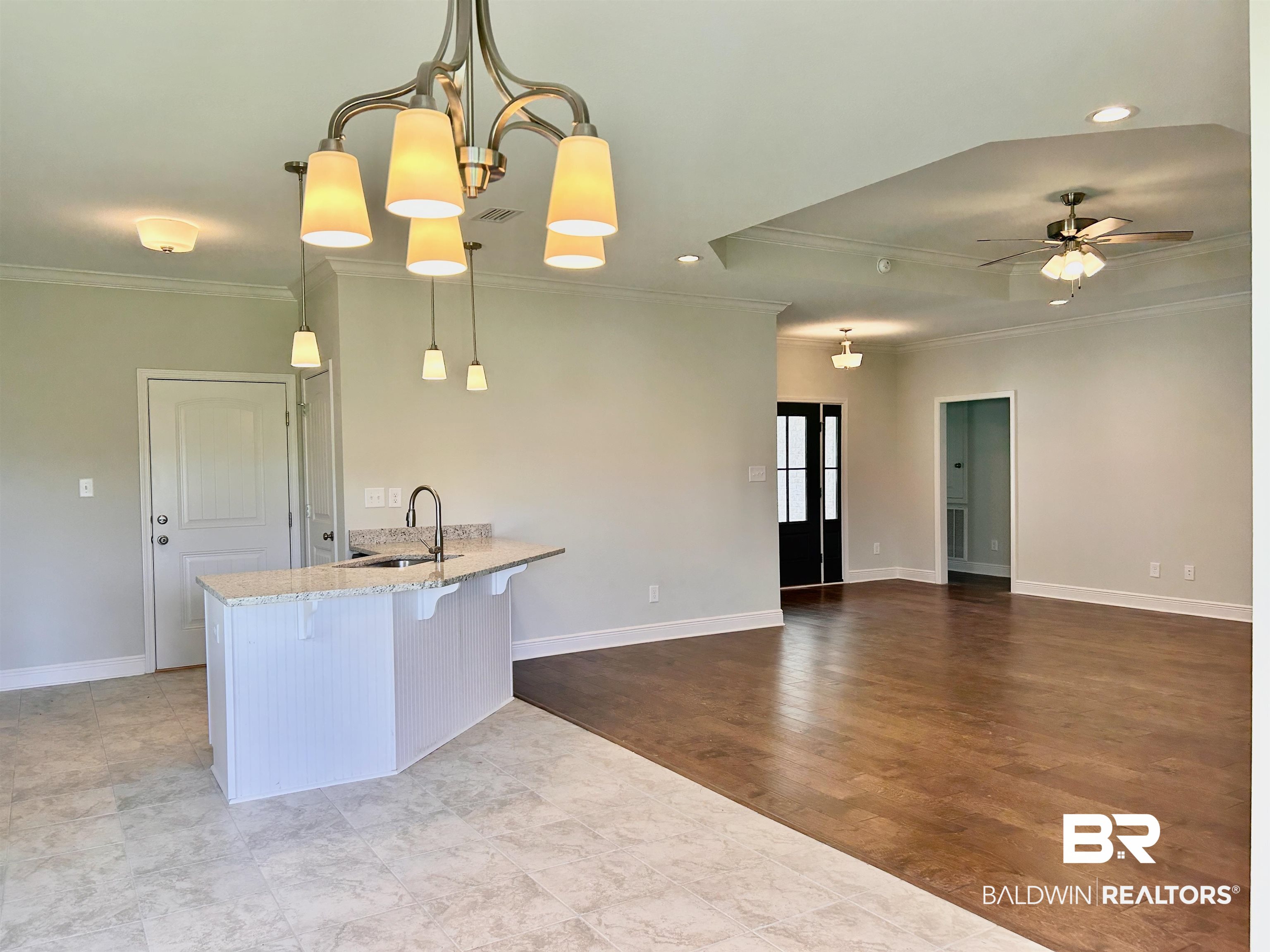 1267 Pembroke Way Foley, AL 36535 - Photo 7 of 17 Kitchen featuring light wood-type flooring, pendant lighting, ceiling fan with notable chandelier, crown molding, and sink