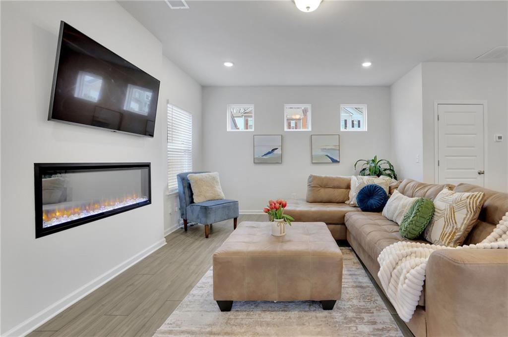 803 Dundee Way Cartersville, GA 30121 - Photo 12 of 37 a living room with furniture and a flat screen tv