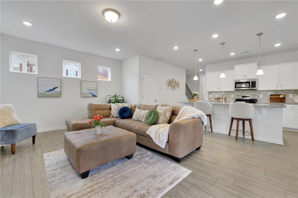 803 Dundee Way Cartersville, GA 30121 - Photo 13 of 37 a living room with furniture and kitchen view with wooden floor