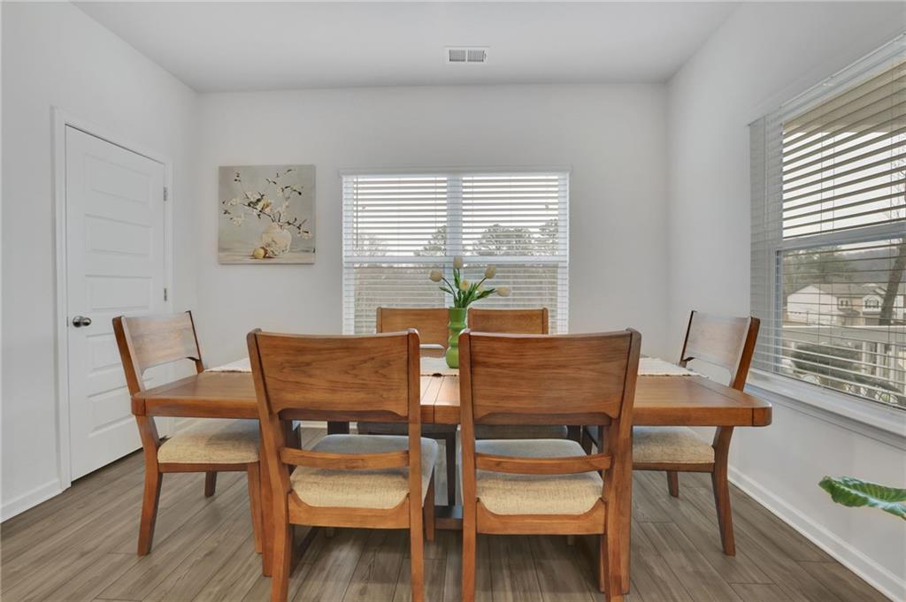 803 Dundee Way Cartersville, GA 30121 - Photo 15 of 37 a view of a dining room with furniture and wooden floor