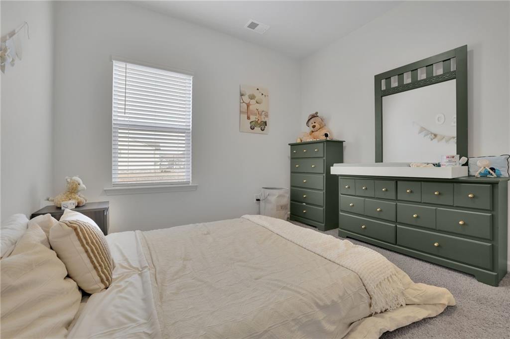 803 Dundee Way Cartersville, GA 30121 - Photo 19 of 37 a bedroom with a bed and a dresser