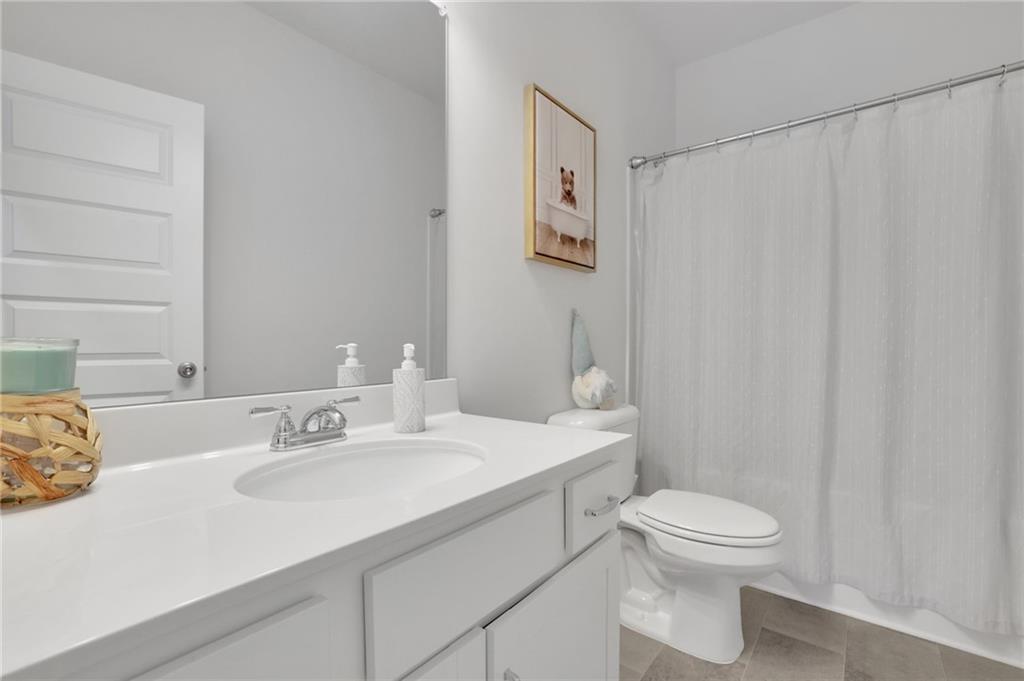 803 Dundee Way Cartersville, GA 30121 - Photo 20 of 37 a bathroom with a sink a toilet and a mirror