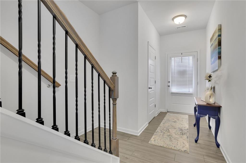 803 Dundee Way Cartersville, GA 30121 - Photo 2 of 37 a view of an entryway with wooden floor and stairs