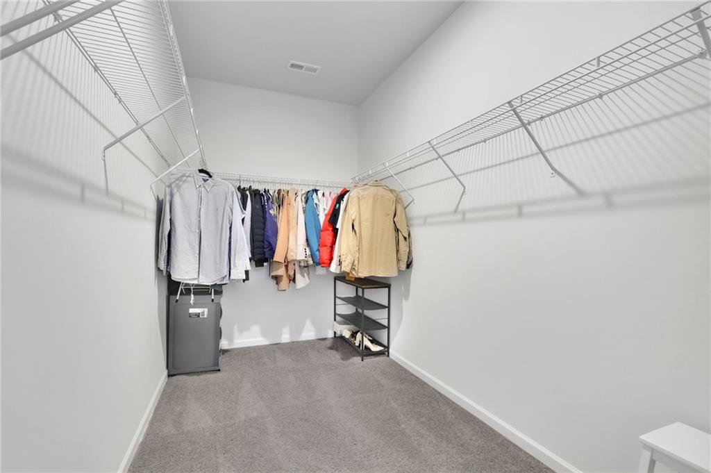 803 Dundee Way Cartersville, GA 30121 - Photo 22 of 37 a view of walk in closet with clothes