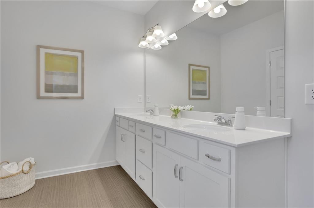 803 Dundee Way Cartersville, GA 30121 - Photo 27 of 37 a bathroom with a double vanity sink and a mirror
