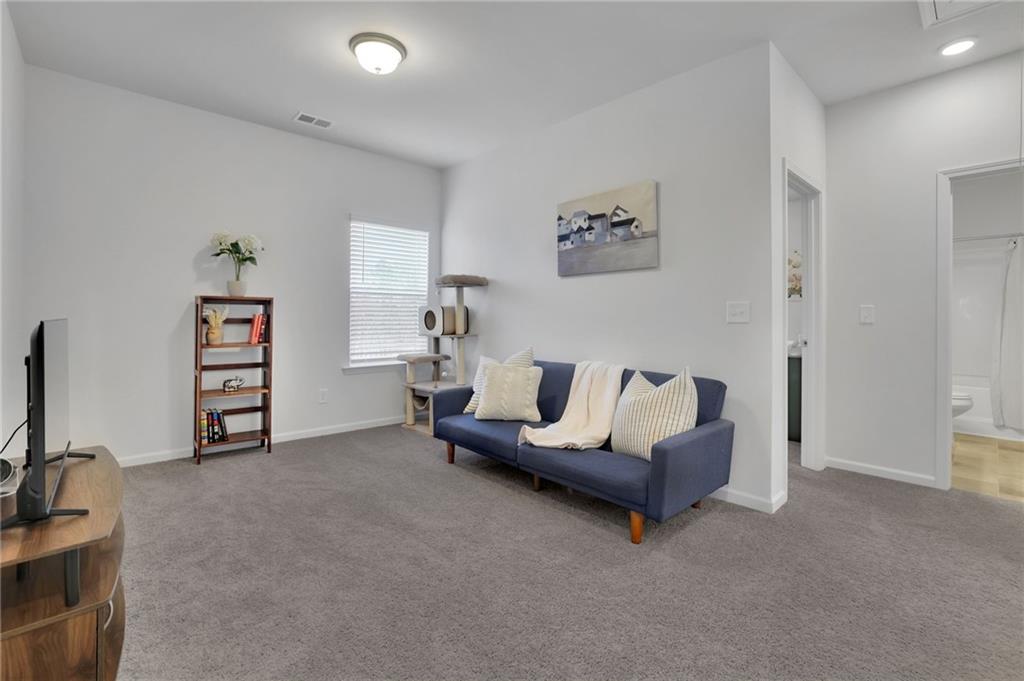 803 Dundee Way Cartersville, GA 30121 - Photo 31 of 37 a living room with furniture and a flat screen tv