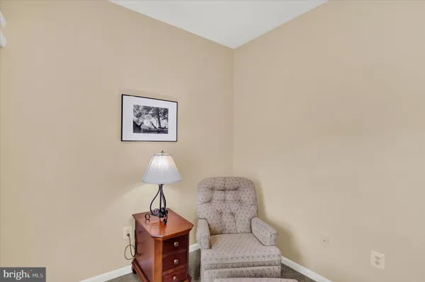a living room with furniture and a lamp