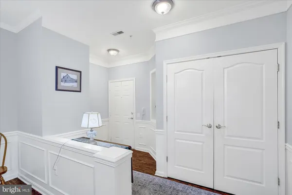 a room that has a dryer and wooden cabinets