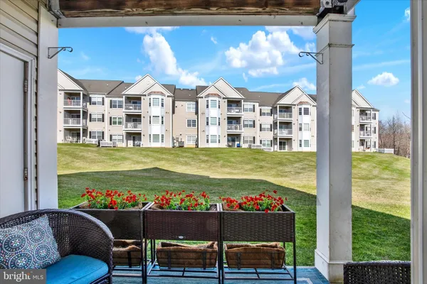 a view of a house with a big yard and sitting area
