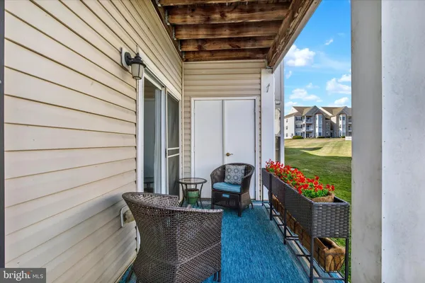 a view of two chairs in the balcony