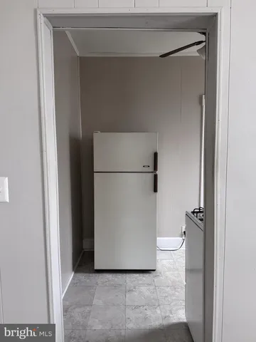 a white toilet sitting in a bathroom next to a sink