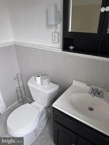 a bathroom with a toilet sink and mirror