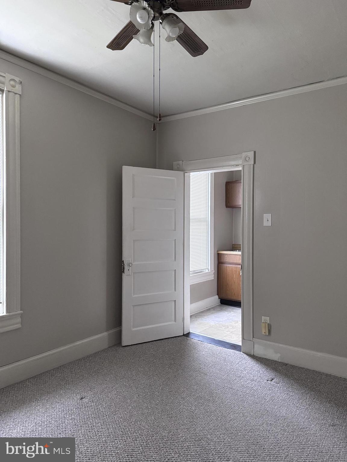 4606 Ridge Avenue Halethorpe, MD 21227 - Photo 23 of 24 an empty room with windows and fan