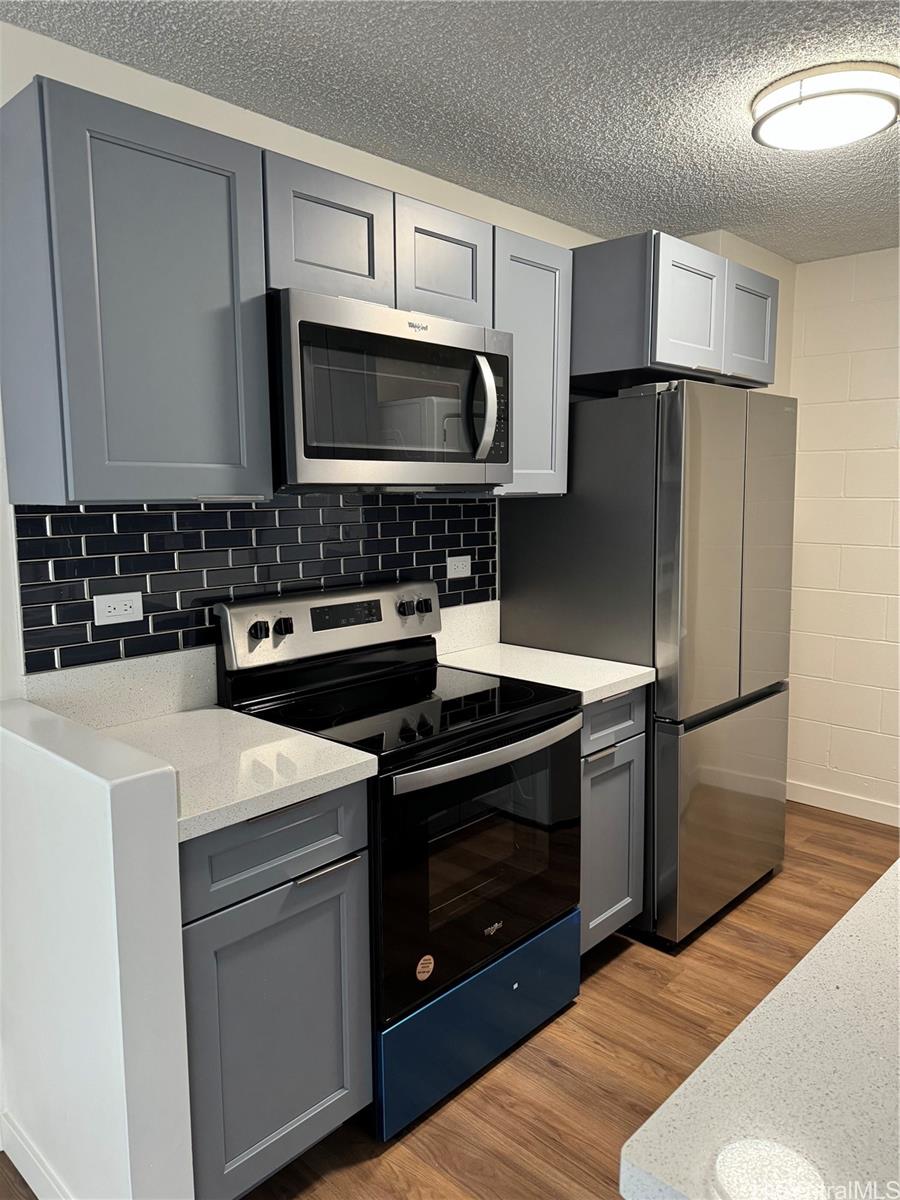 a kitchen with a stove microwave and refrigerator
