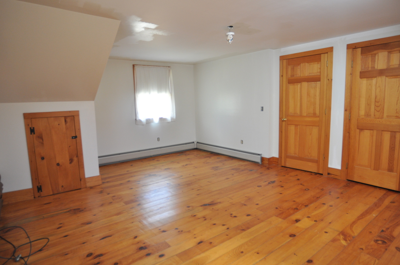 401 Polikoff Road Sheffield, MA 01222 - Photo 14 of 17 an empty room with wooden floor and windows