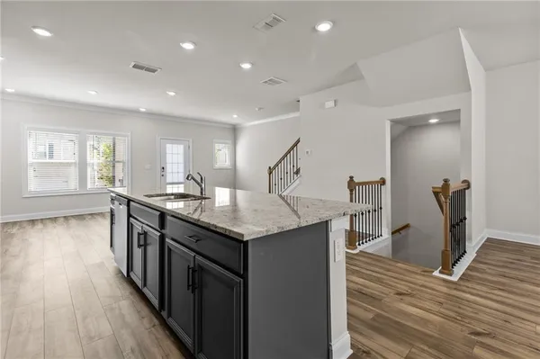a kitchen with counter top space and wooden floor