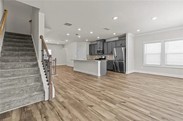 a view of a kitchen with cabinets and wooden floor