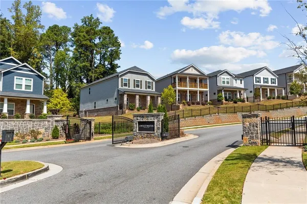 a patio with table and chairs and potted plants