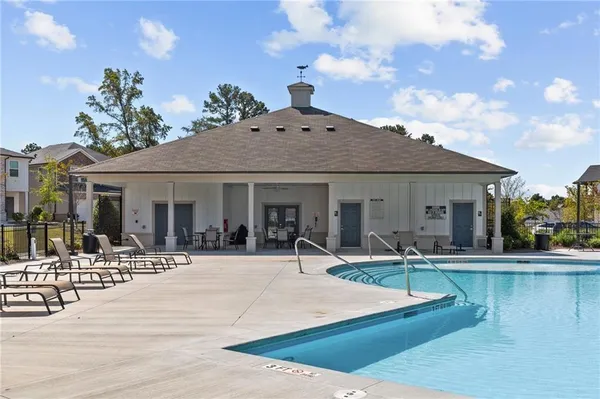 a front view of house with yard and ocean view