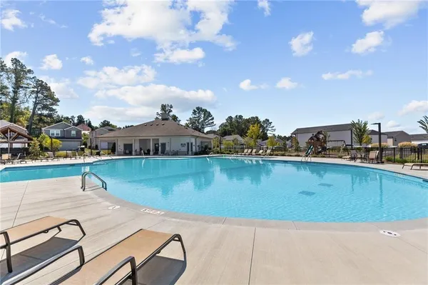 a view of swimming pool with outdoor seating