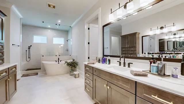a bathroom with a double vanity sink mirror and bathtub