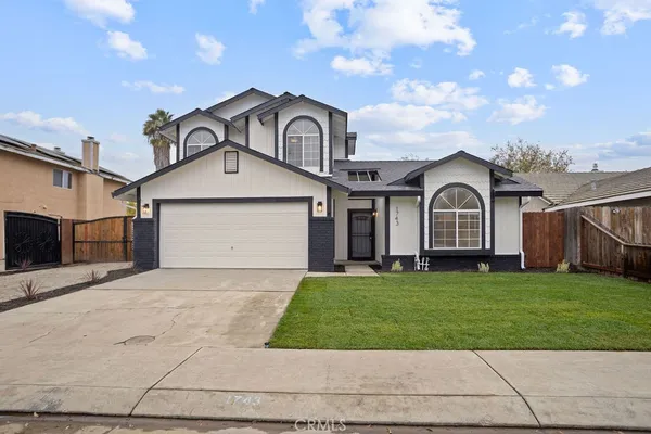 a view of a yard in front of a house with garage