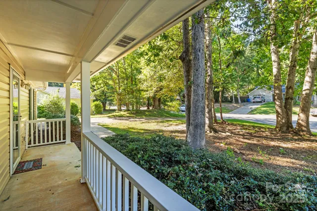 a view of a porch with wooden floor and fence