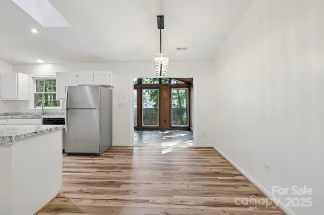 a kitchen with stainless steel appliances a refrigerator and a stove top oven