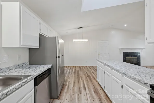a kitchen with a sink stove and refrigerator