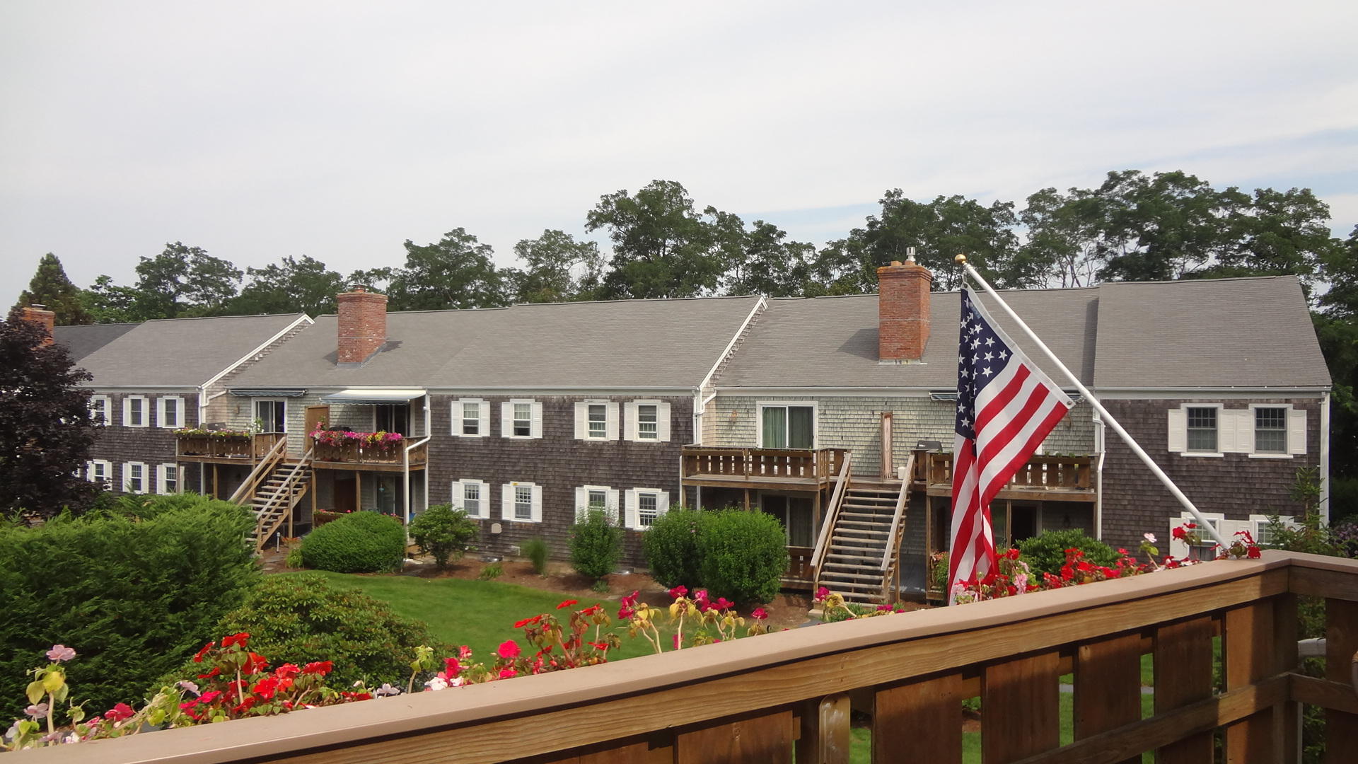 683 Old Post (rt 6a Main St ) Road, Unit 16 Dennis, MA 02638 - Photo 18 of 23 a view of houses with a yard and potted plants