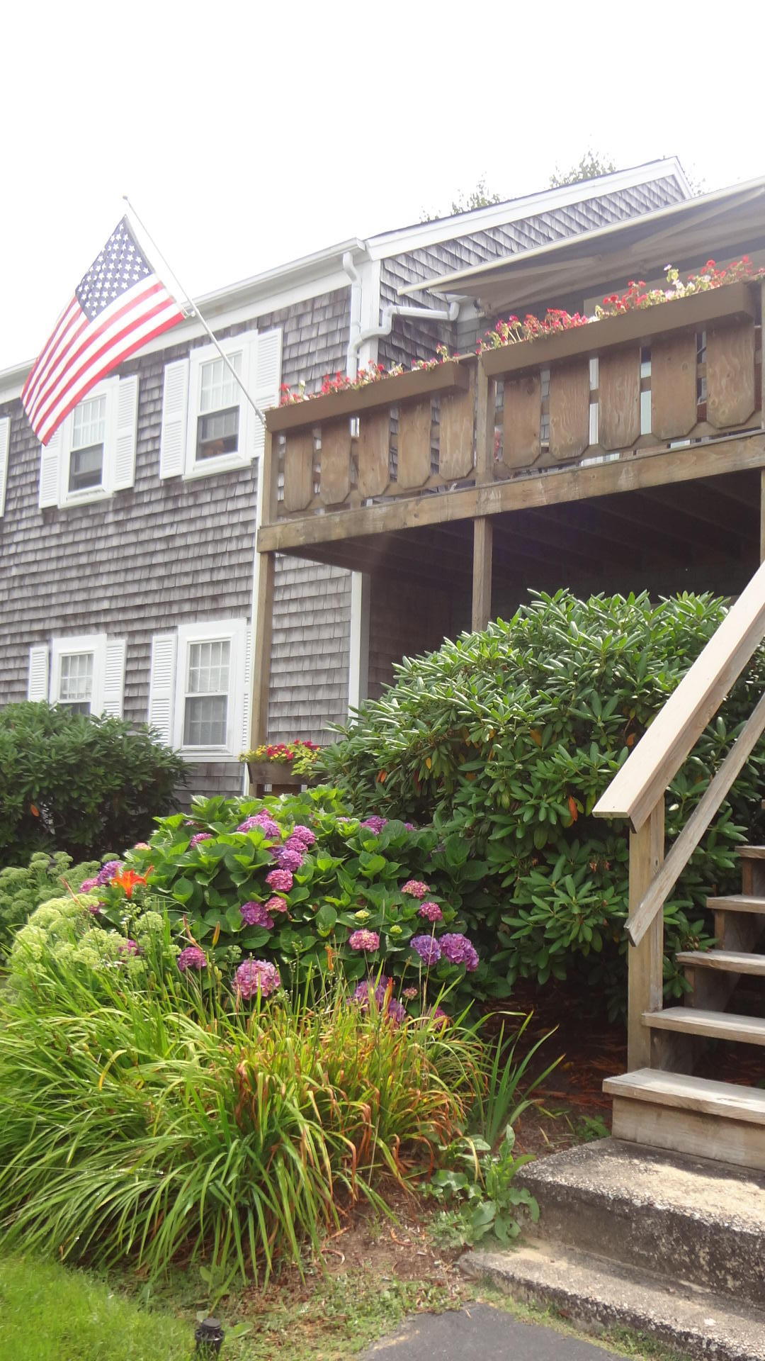 683 Old Post (rt 6a Main St ) Road, Unit 16 Dennis, MA 02638 - Photo 19 of 23 a flower garden is sitting in front of a house