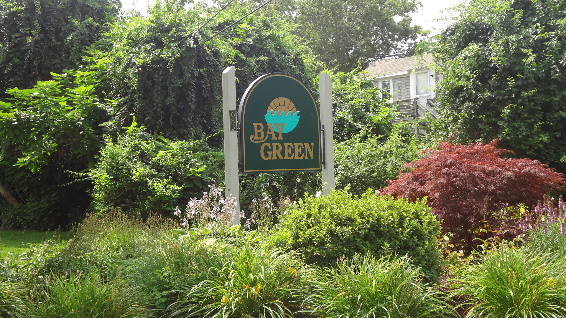 683 Old Post (rt 6a Main St ) Road, Unit 16 Dennis, MA 02638 - Photo 2 of 23 a sign broad in front of the red tree