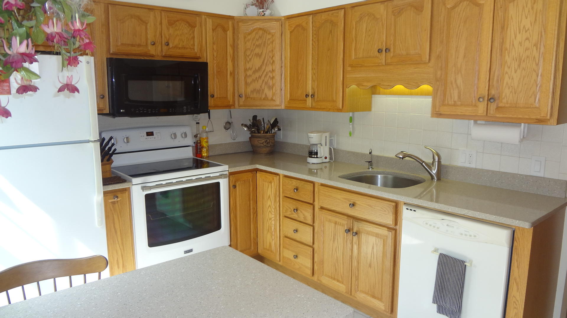 683 Old Post (rt 6a Main St ) Road, Unit 16 Dennis, MA 02638 - Photo 10 of 23 a kitchen with stainless steel appliances a stove a microwave a sink and cabinets