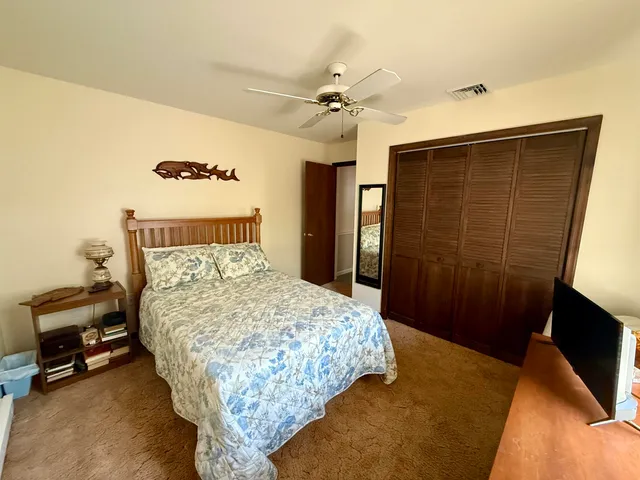 a bedroom with a bed and a mirror