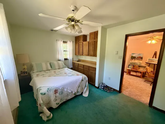 a spacious bedroom with a bed and a mirror