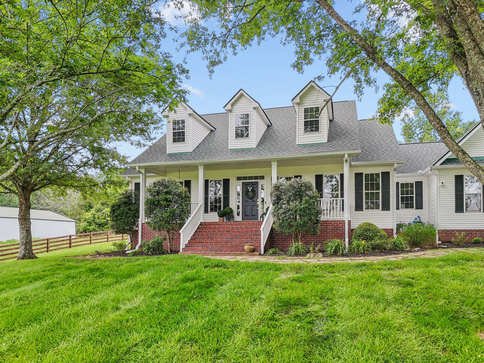 1387 Floyd Road Eagleville, TN 37060 - Photo 2 of 100 a front view of a house with garden