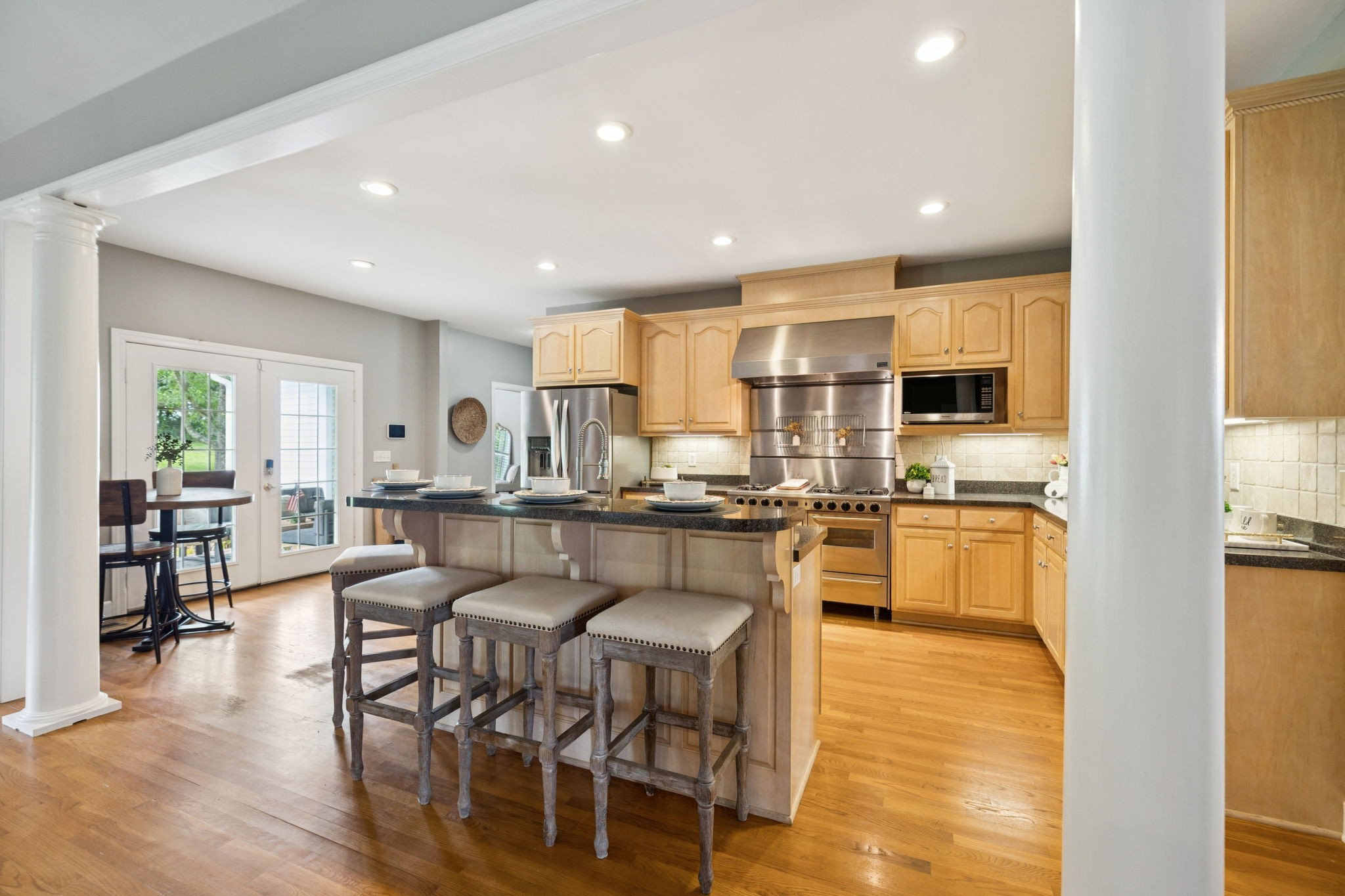 1387 Floyd Road Eagleville, TN 37060 - Photo 30 of 100 a kitchen with stainless steel appliances kitchen island granite countertop a table chairs and a refrigerator