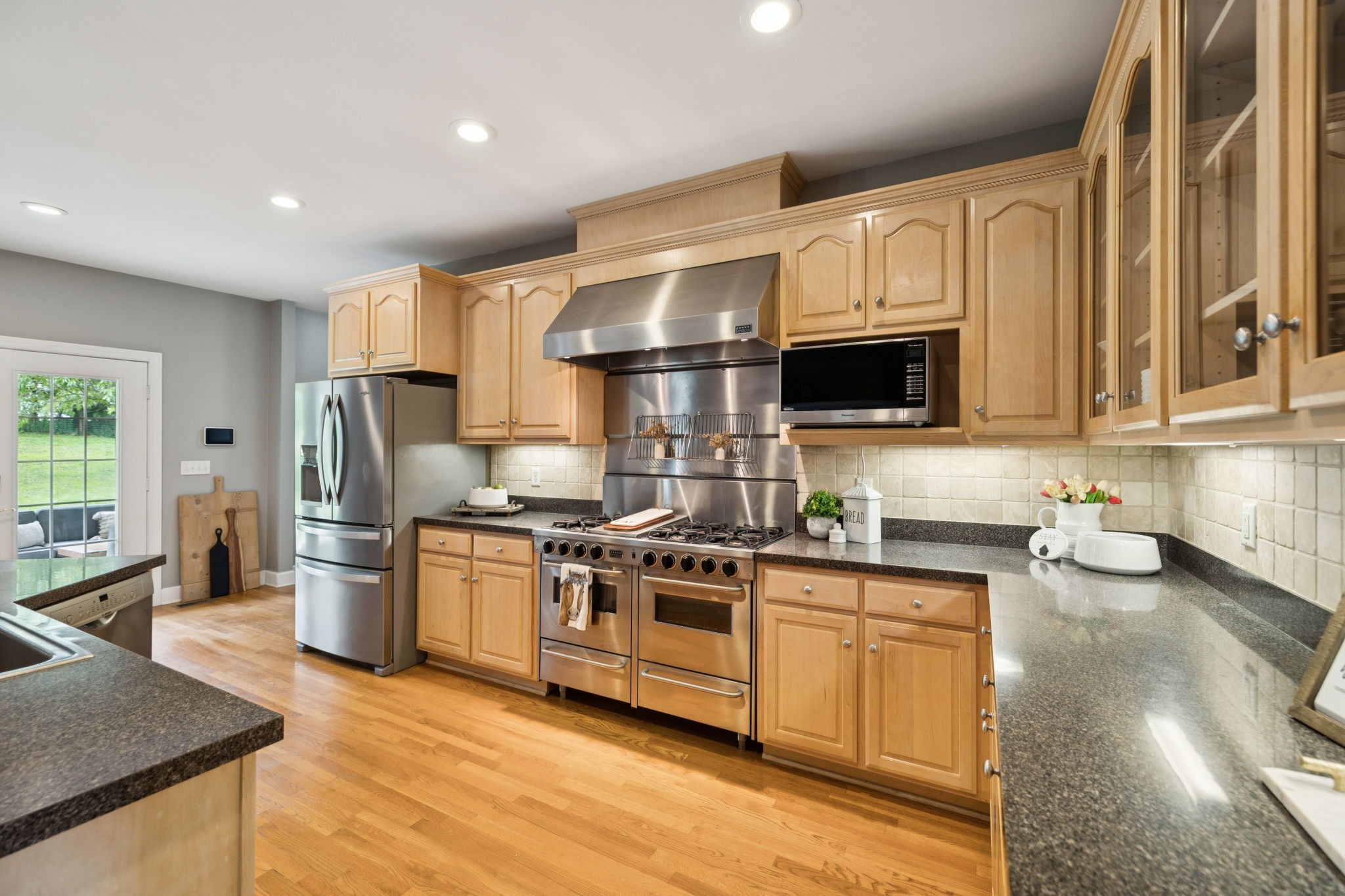 1387 Floyd Road Eagleville, TN 37060 - Photo 35 of 100 a kitchen with stainless steel appliances a stove a sink a refrigerator white cabinets and wooden floor