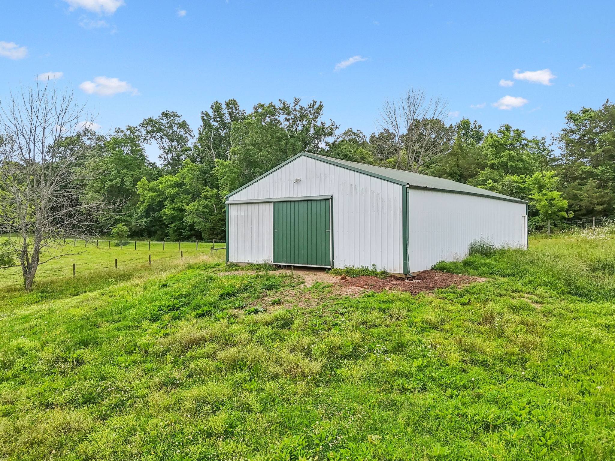 1387 Floyd Road Eagleville, TN 37060 - Photo 82 of 100 a view of a backyard with potted plants and large tree
