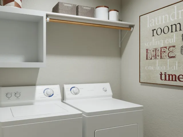 a bedroom with a bed and a lamp on dresser