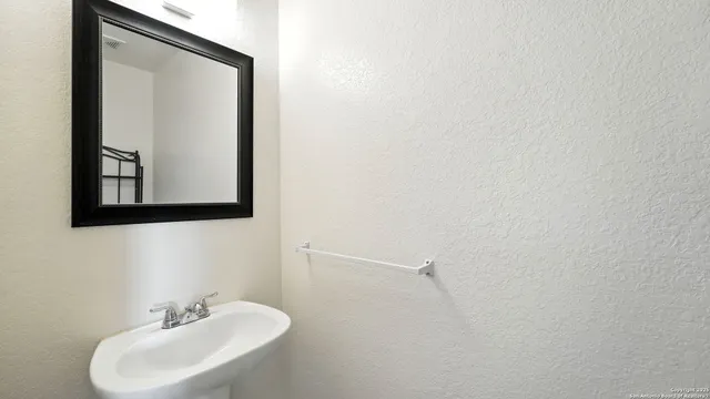 a bathroom with a sink and a mirror