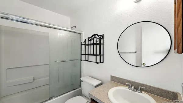 a bathroom with a sink a mirror and a shower