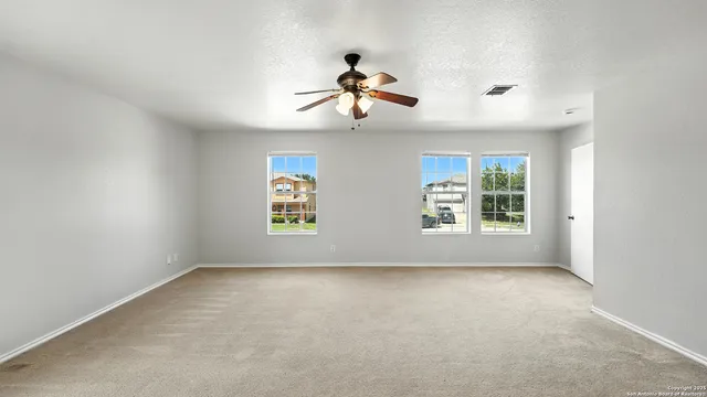 a view of room with window and ceiling fan