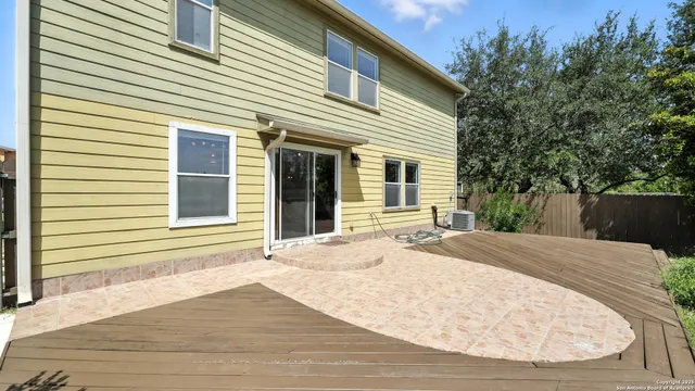 a view of a house with a wooden deck