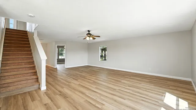 a view of an empty room and wooden floor