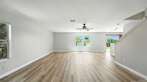 wooden floor in an empty room with a window