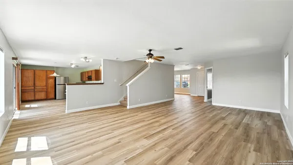 a view of a room with wooden floor and entryway