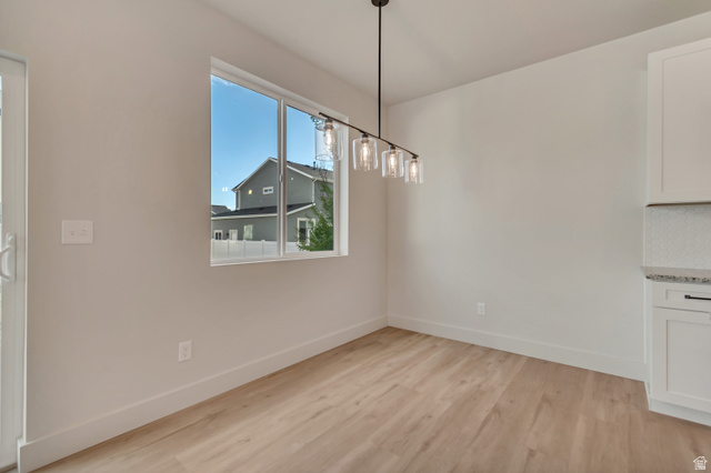 2535 West Santa Fe Drive Mapleton, UT 84664 - Photo 9 of 26 Unfurnished dining area with light wood finished floors and baseboards
