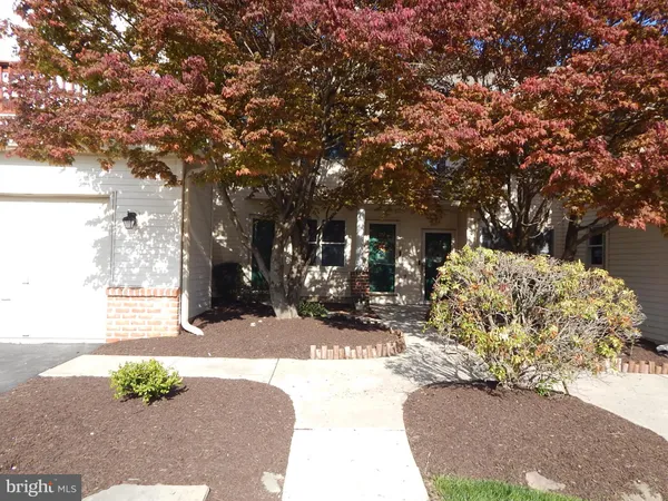 a view of a pathway of a house with a yard